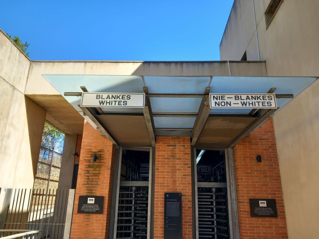 This image shows the entrance to the Apartheid Museum with separate gates for whites and non-whites to show how life would have been in the apartheid era