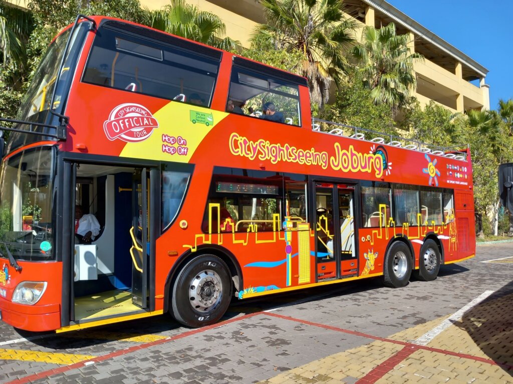 This image shows a bright red double-decker City Sightseeing bus