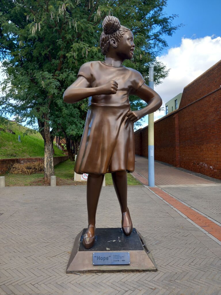 This photo shows a statue of a young girl named Hope