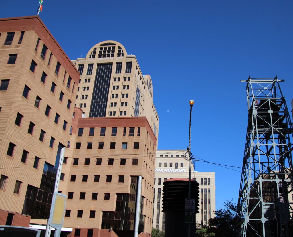 This image shows the contrast between the smart, concrete-built, Art Deco mining offices and the stark industrial mine shaft