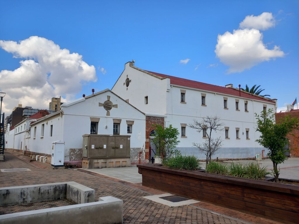 This photo shows the exterior of the Old Fort.  It is painted in white and has a red tiled roof.