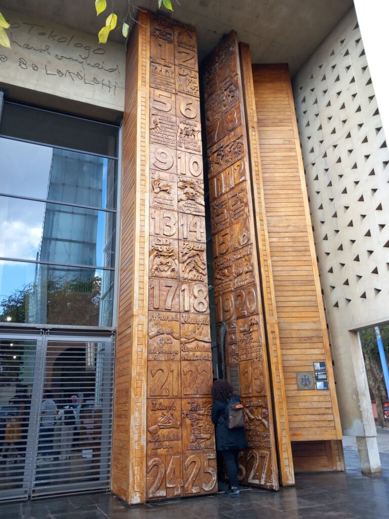 This photo shows the huge carved wooden doors at the entrance to the constitutional court