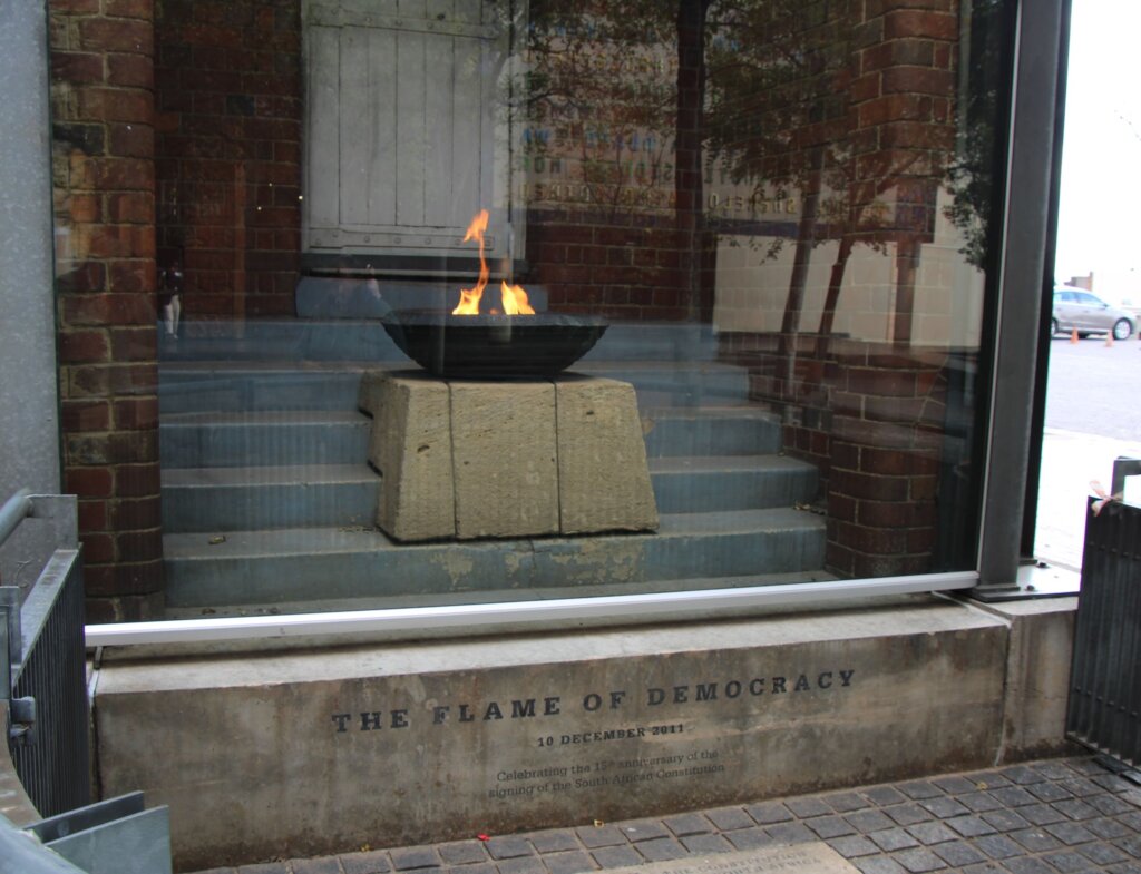 This photo shows the flame of democracy, a small flame that burns all the time and is displayed behind glass