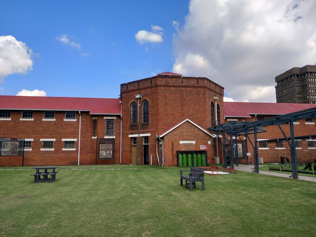 This photo shows the exterior of the women's prison built in red brick with a hexagonal central building