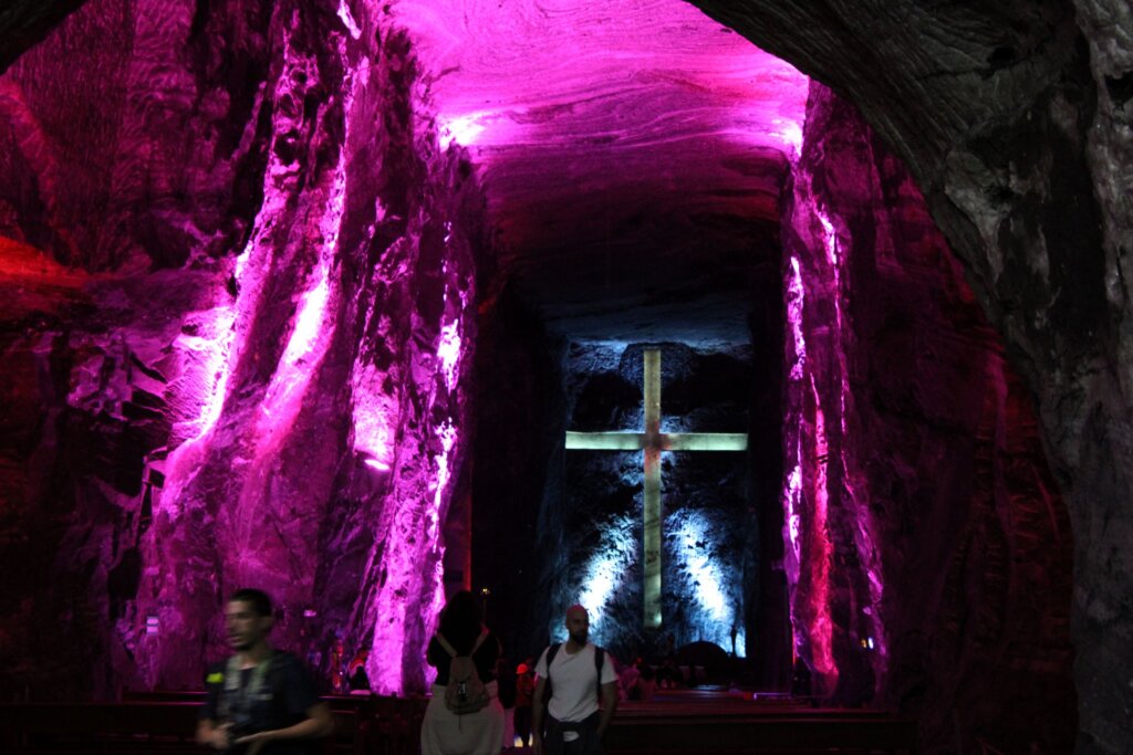 This image shows the huge cross in the main nave of the salt cathedral illuminated in bright pink