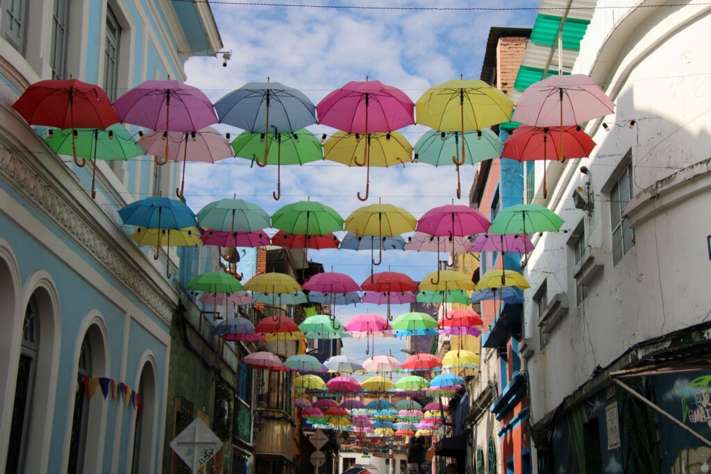 This image shows colourful umbrellas hung across a street